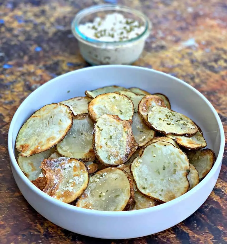 air fryer potato chips in a white bowl with dip