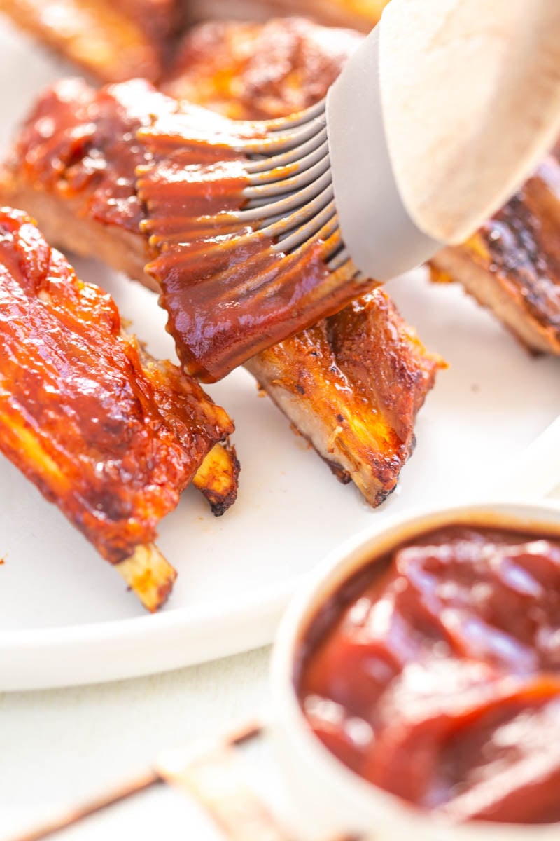 air fryer ribs drizzled in bbq sauce