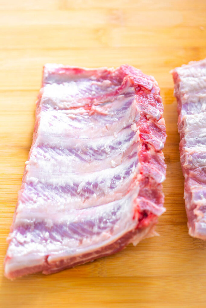 raw ribs on a cutting board