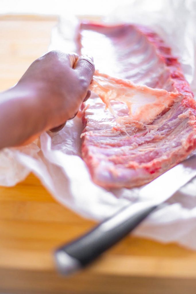 raw rack of ribs on a cutting board