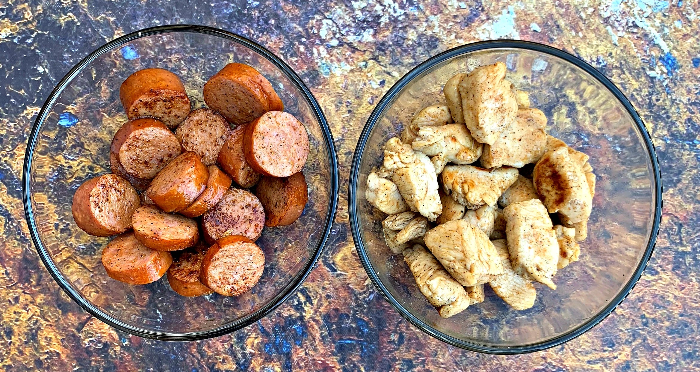 chopped sausage and chicken in bowls