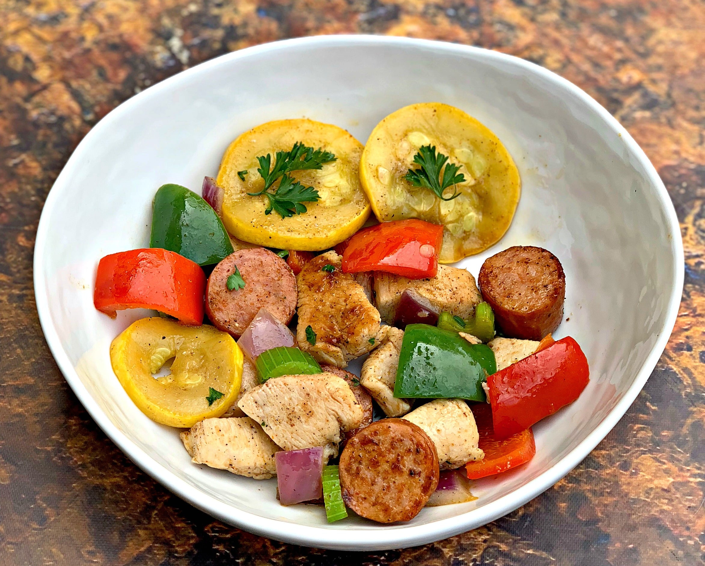 cajun chicken sausage skillet in a white bowl