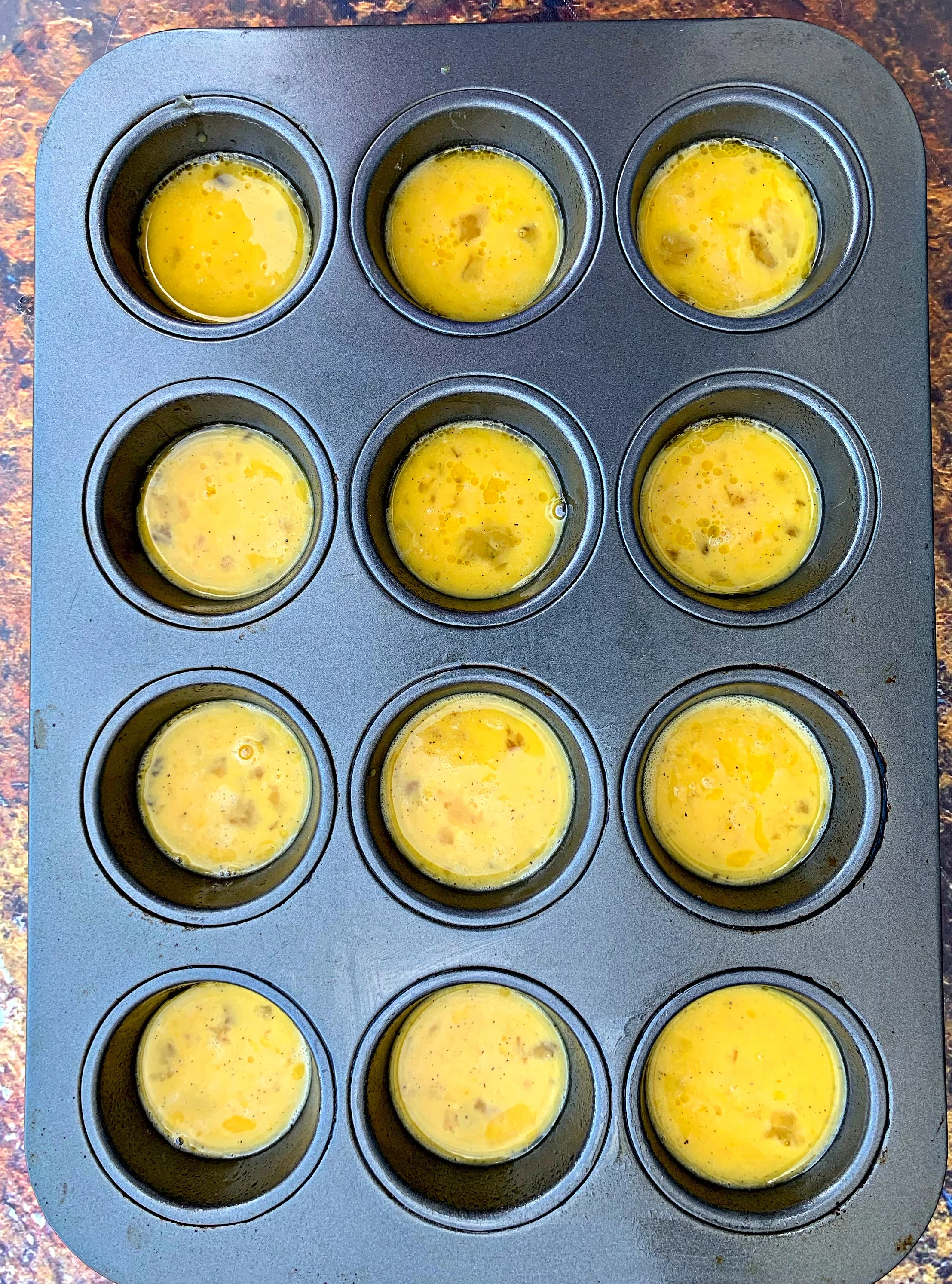 raw eggs in a muffin tin