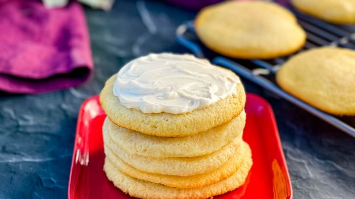 keto low carb sugar cookies on a red plate with cream cheese frosting