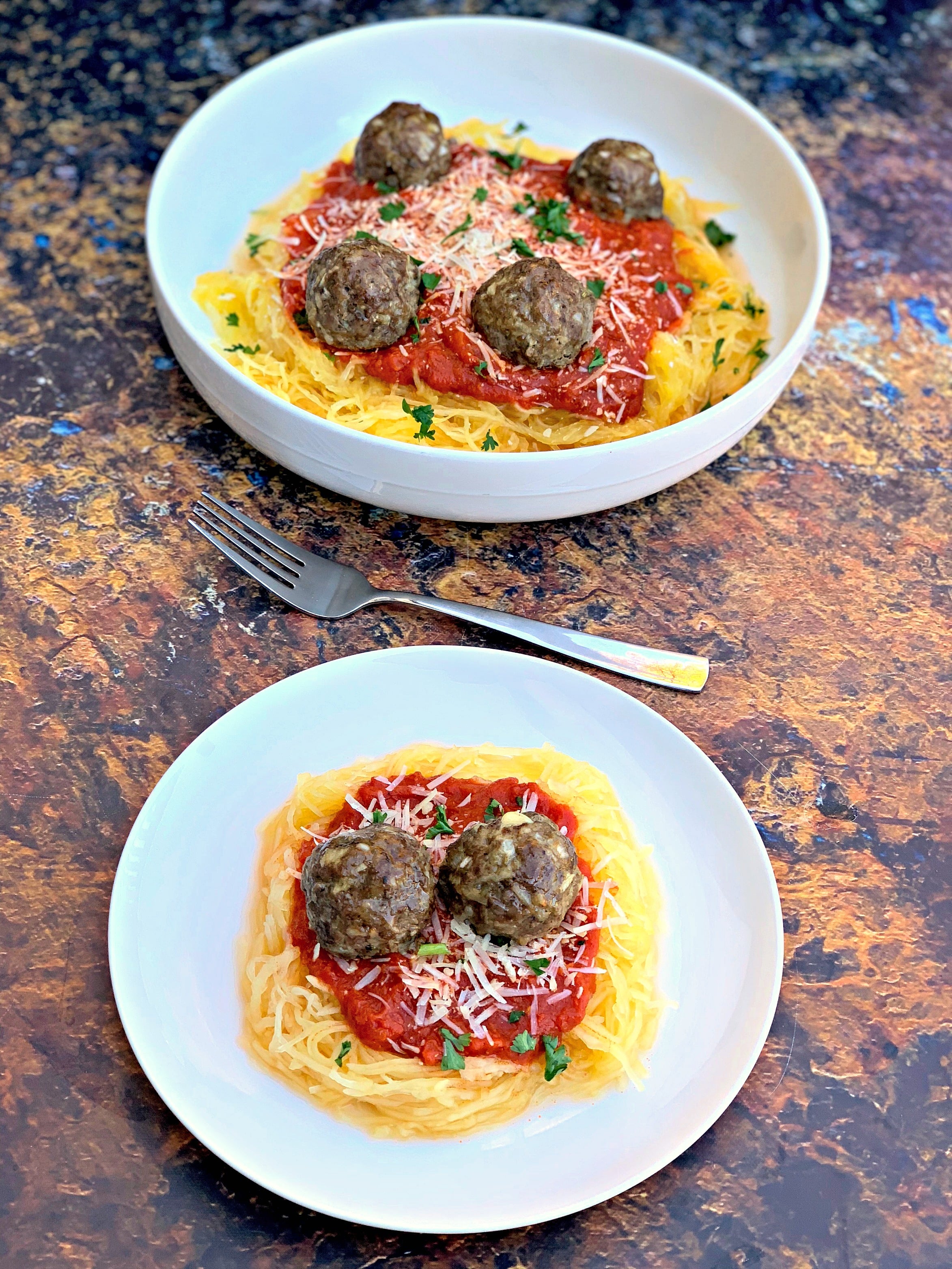 spaghetti squash marinara in a white bowl with a white plate