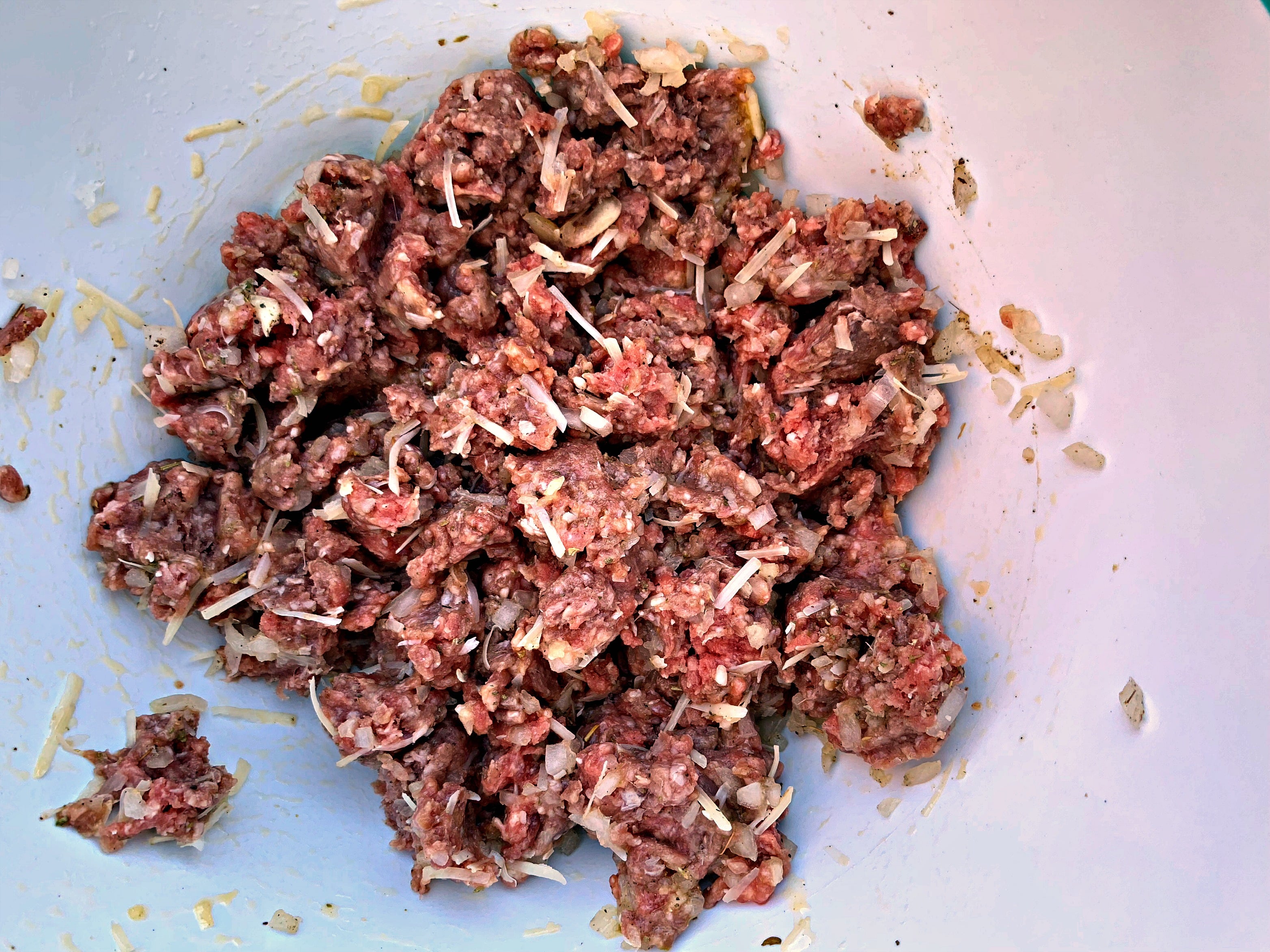 raw beef in a bowl with seasoning