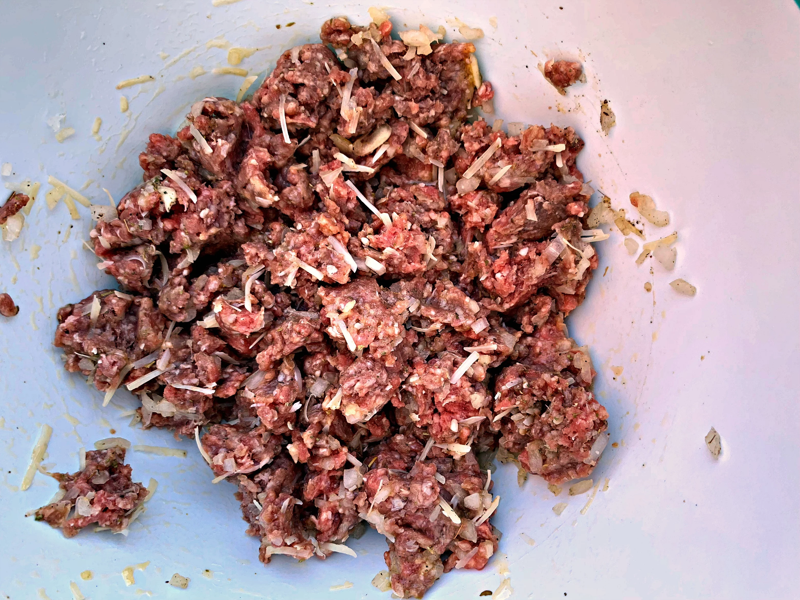 raw beef in a bowl with seasoning