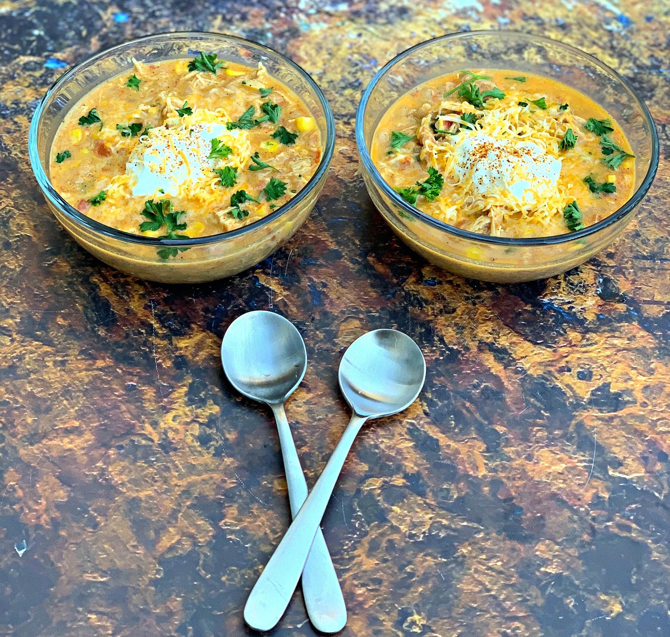 instant pot white chicken chili in 2 bowls with spoons
