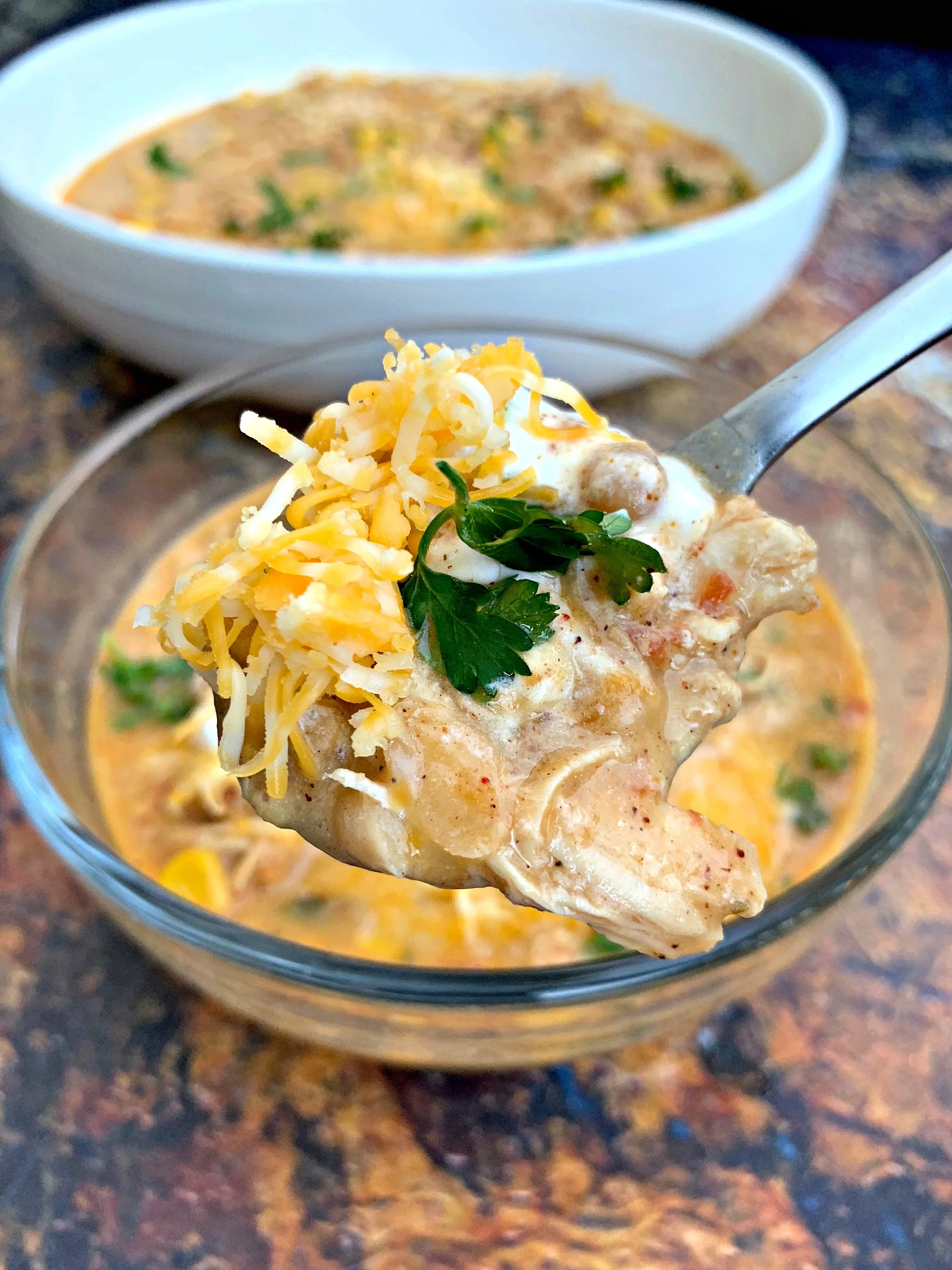 a close up of a spoon of instant pot white chicken chili