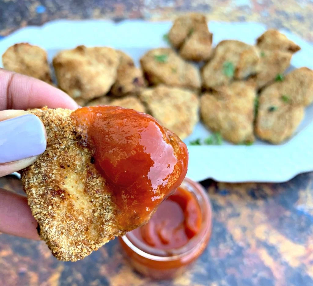 air fryer chicken nuggets on a white plate with ketchup