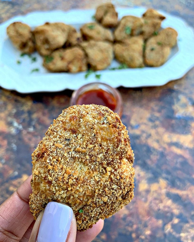 person holding air fryer chicken nugget