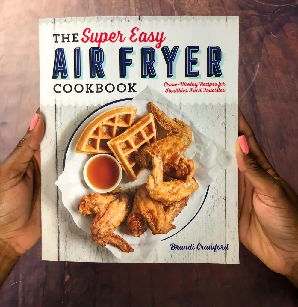 person holding air fryer cookbook