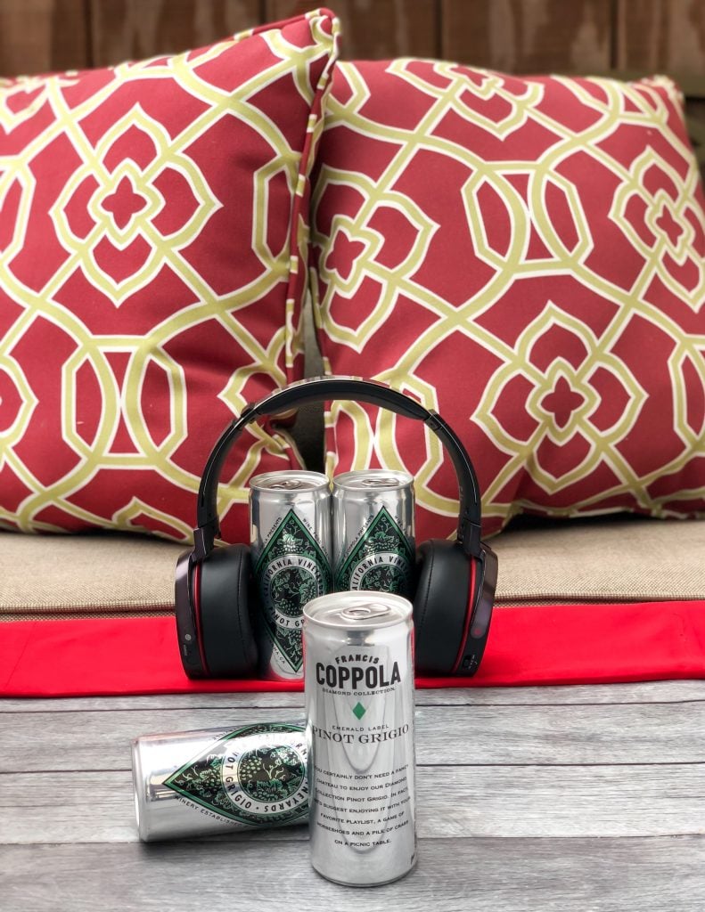 wine on a table with headphones