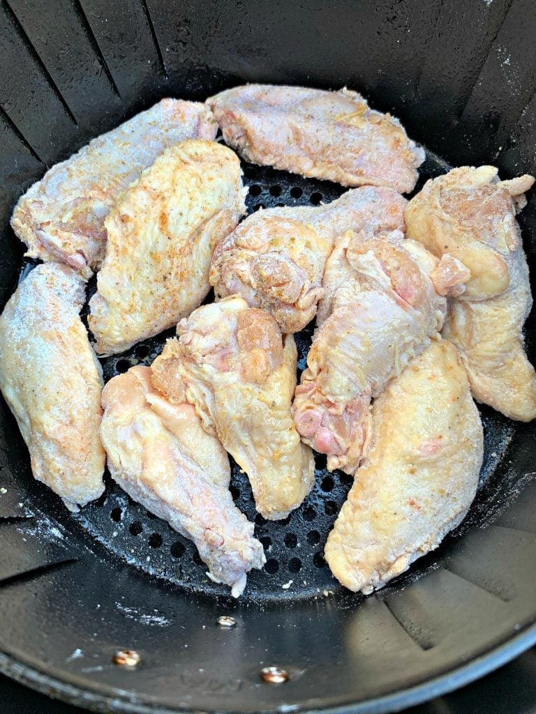 raw chicken wing in air fryer basket