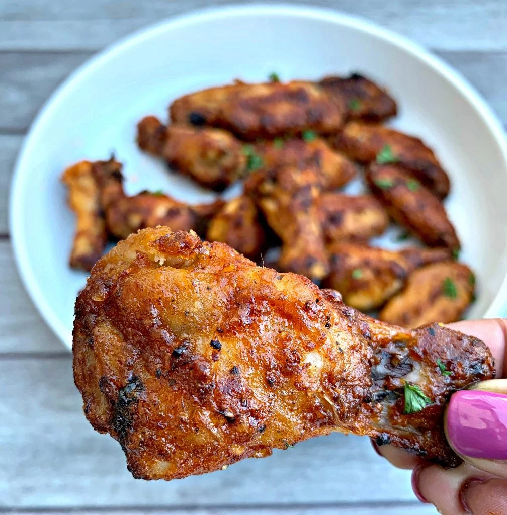 person holding air fryer honey bbq chicken wing