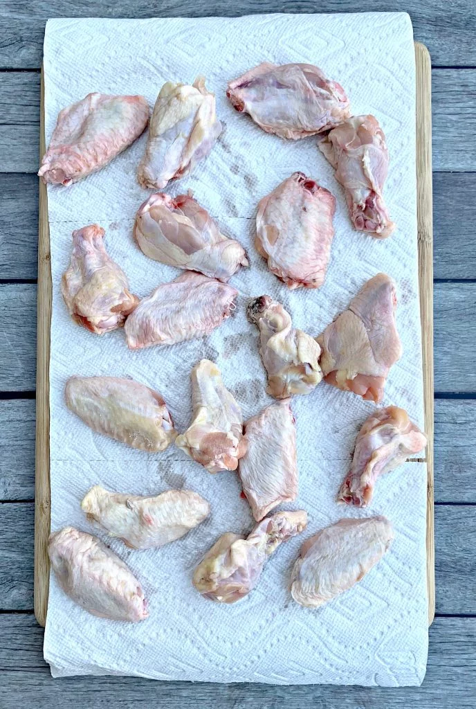 raw chicken wings on a cutting board
