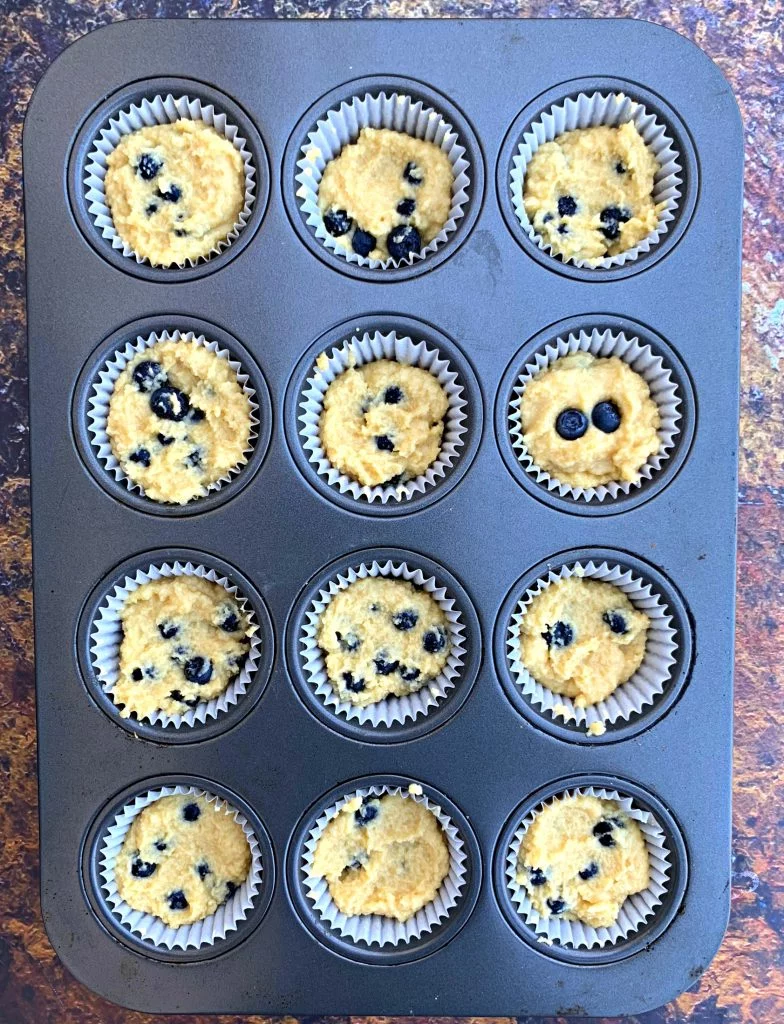 keto blueberry muffins in a muffin tin