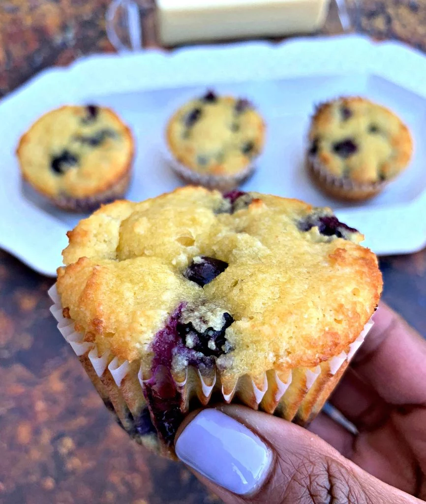 person holding keto blueberry muffins