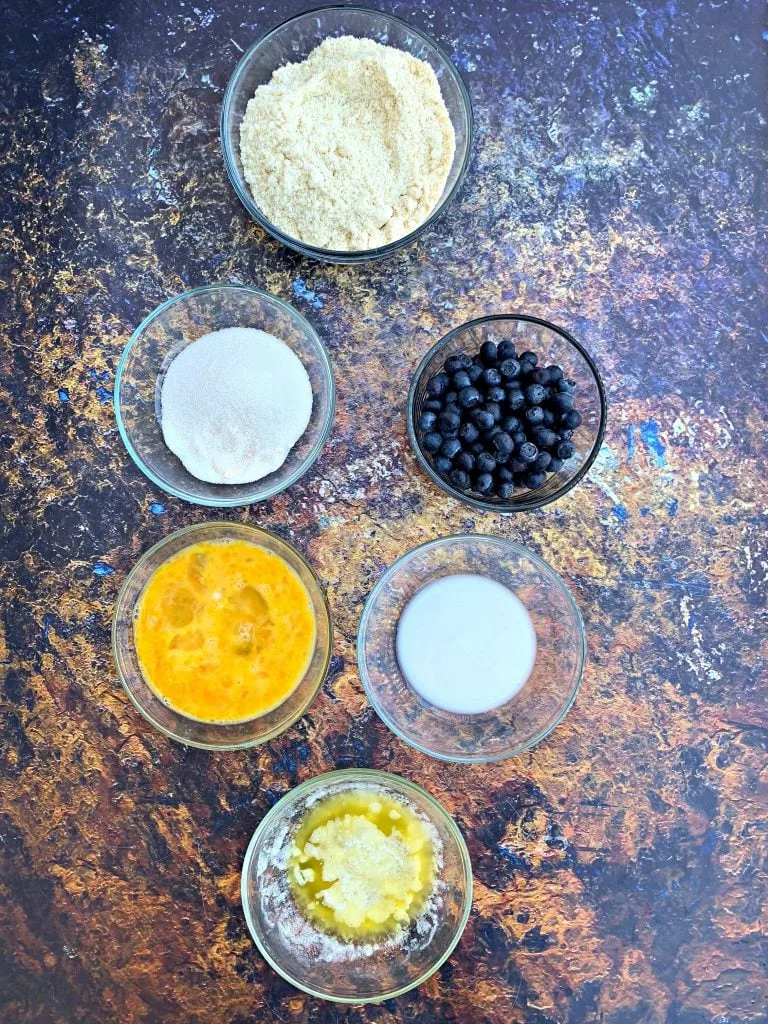 ingredients for keto blueberry muffins on a flat surface