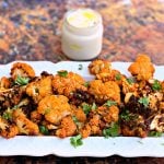 keto buffalo cauliflower wings on a white plate with dip