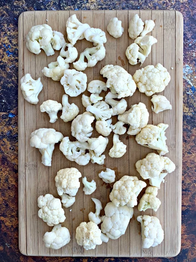 raw sliced cauliflower on a cutting board