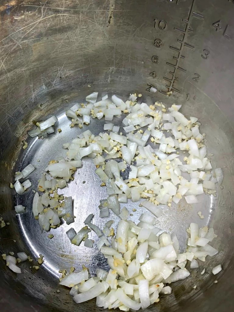 chopped onions and garlic in an instant pot 