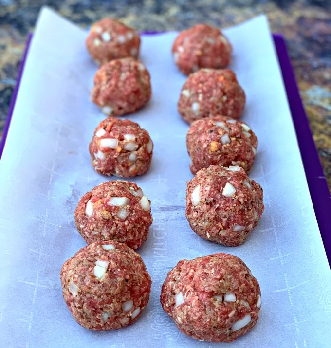 raw keto low carb meatballs on parchment paper