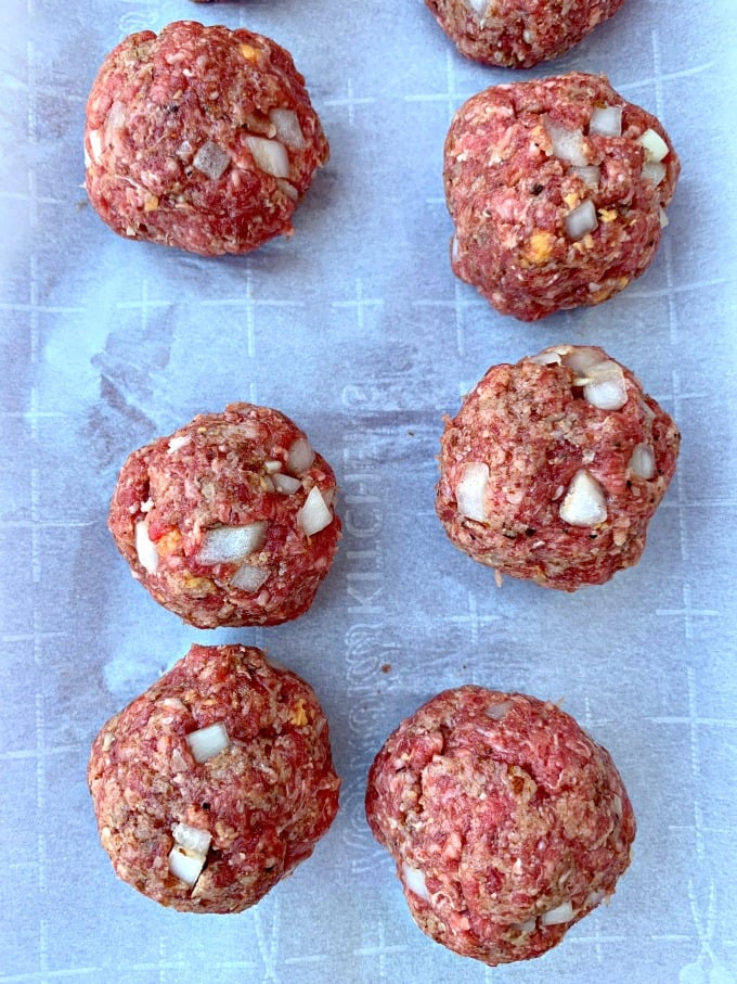 raw keto low carb meatballs on parchment paper