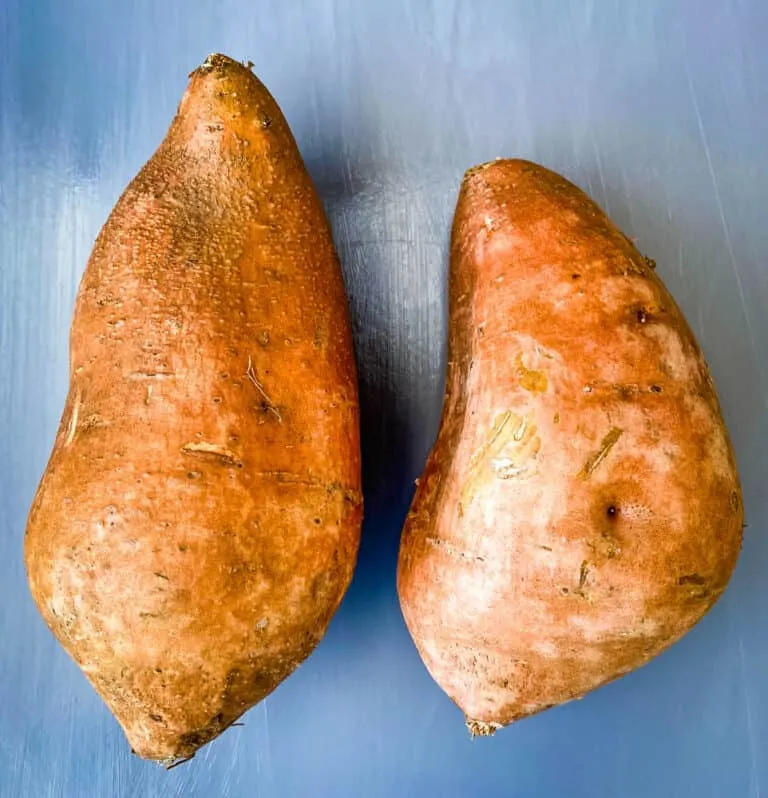 air fryer loaded sweet potatoes with butter on a white plate