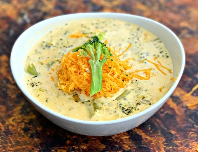 keto low carb instant pot broccoli cheddar soup in a white bowl