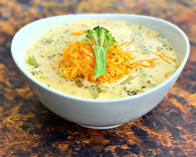 keto low carb instant pot broccoli cheddar soup in a white bowl