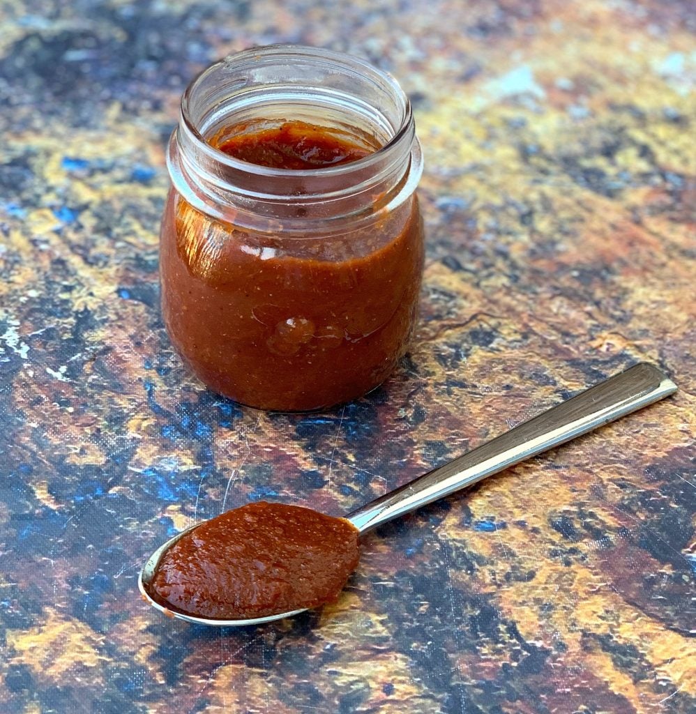 keto low carb bbq sauce in a jar and with a spoon of sauce