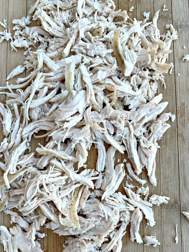 shredded chicken on a cutting board