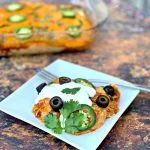 keto low carb enchilada casserole on a white plate and in a baking dish