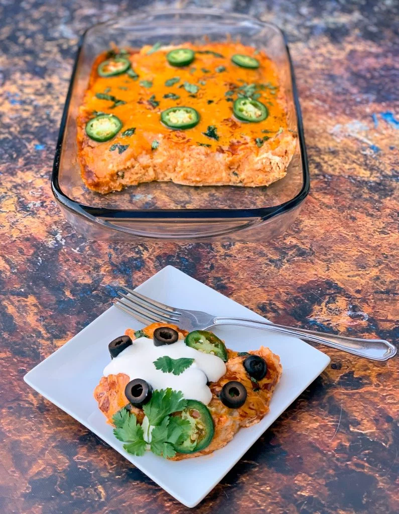 keto low carb enchilada casserole on a white plate and in a baking dish