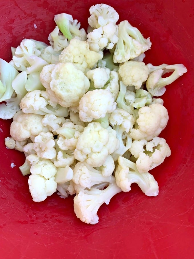 steamed cauliflower in a red bowl