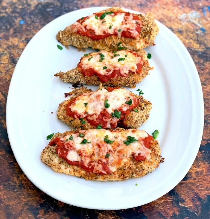 keto parmesan chicken on a white plate