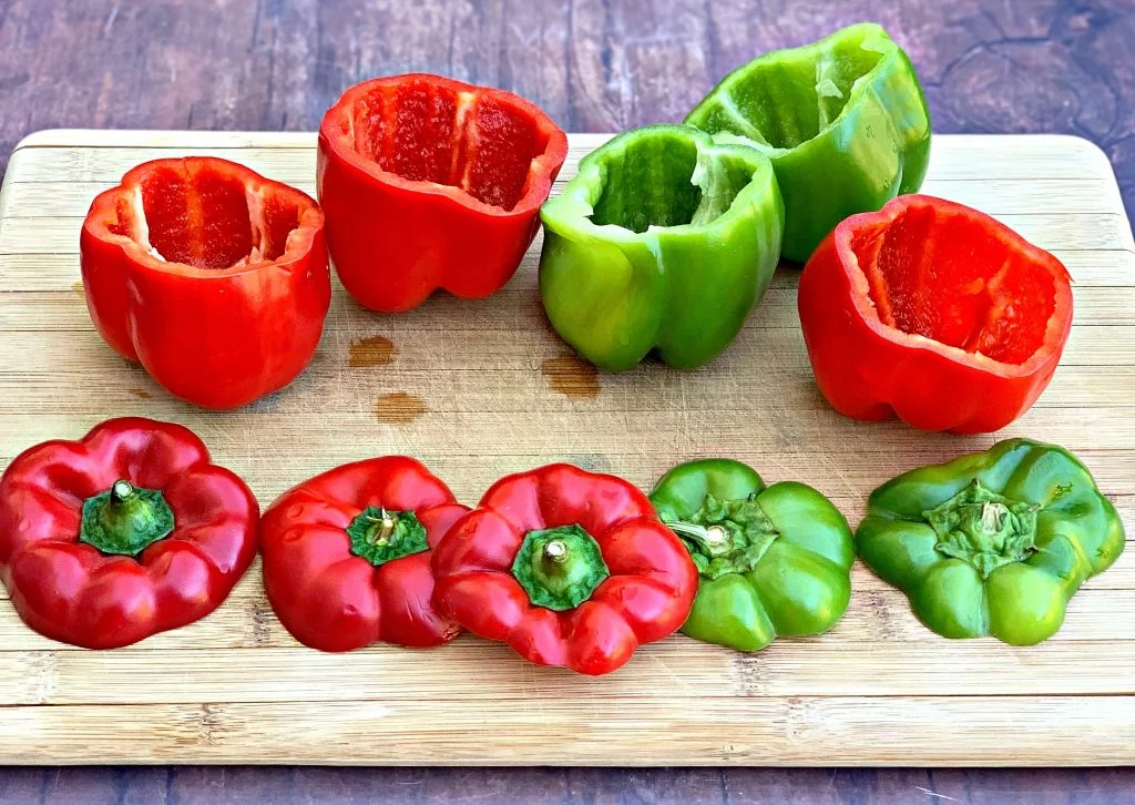 red and green fresh peppers on a cutting board