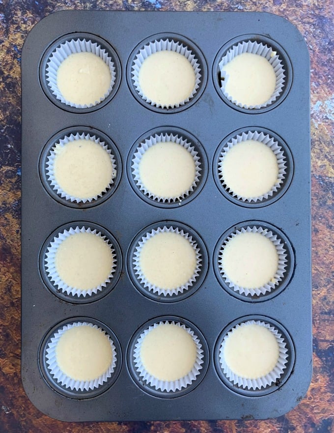 keto vanilla buttercream cupcakes batter in a large muffin tin