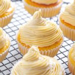 person holding keto vanilla buttercream cupcake