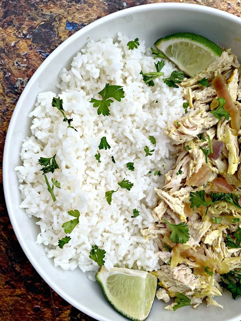 curry chicken and jasmine rice in a white bowl