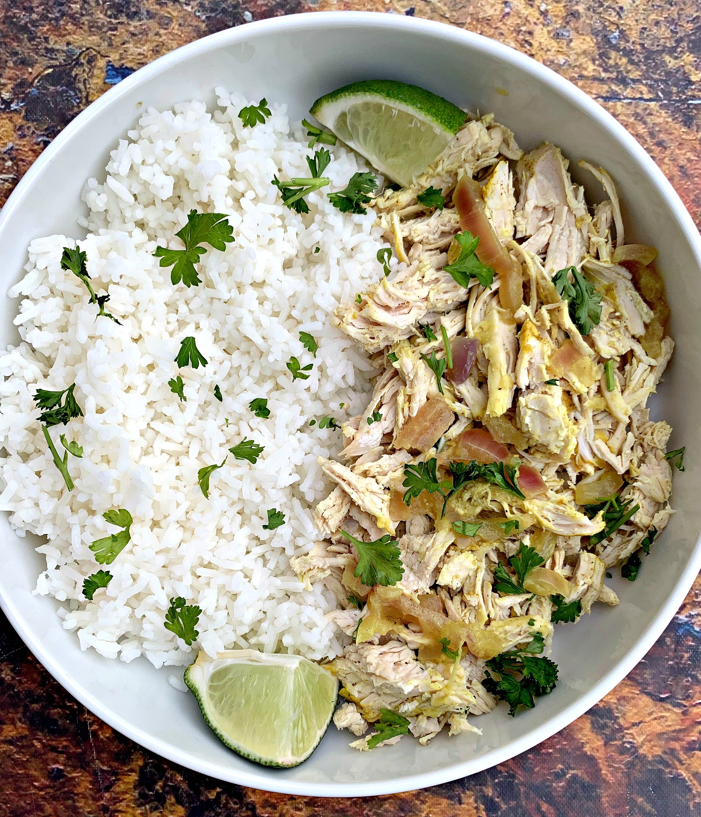 curry chicken and jasmine rice in a white bowl