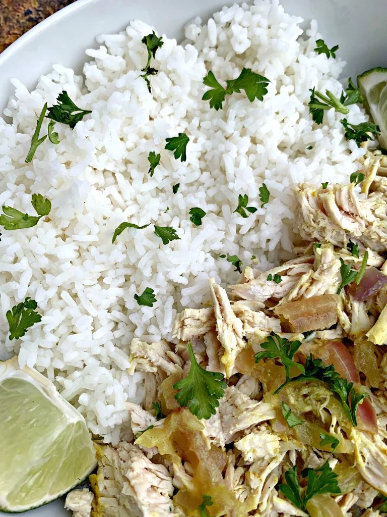 curry chicken and jasmine rice in a white bowl