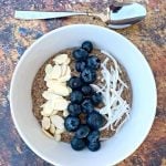 keto hemp oatmeal with blueberries, almonds, and coconut in a white bowl
