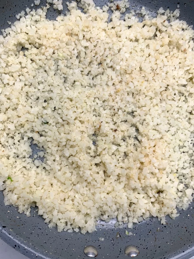 cooked cauliflower rice in a skillet
