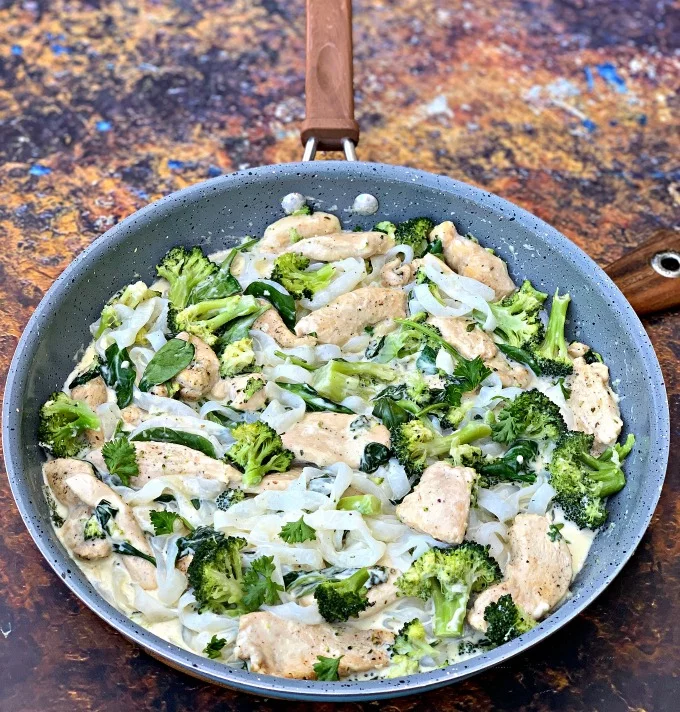 keto chicken alfredo with broccoli and spinach in a skillet
