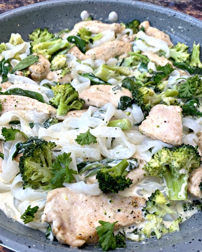 keto chicken alfredo with broccoli and spinach in a skillet