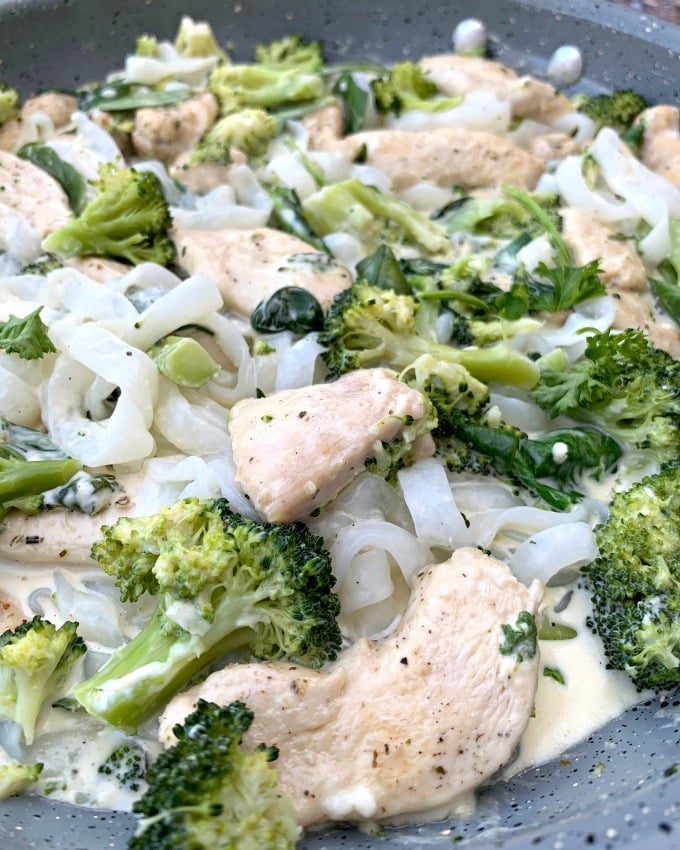 keto chicken alfredo with broccoli and spinach in a skillet