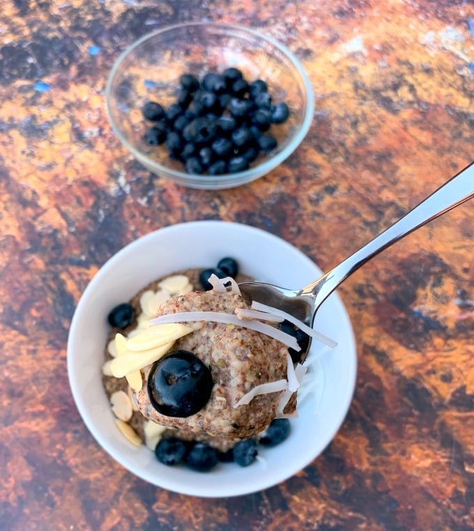 a person holding a spoon of keto hemp oatmeal 