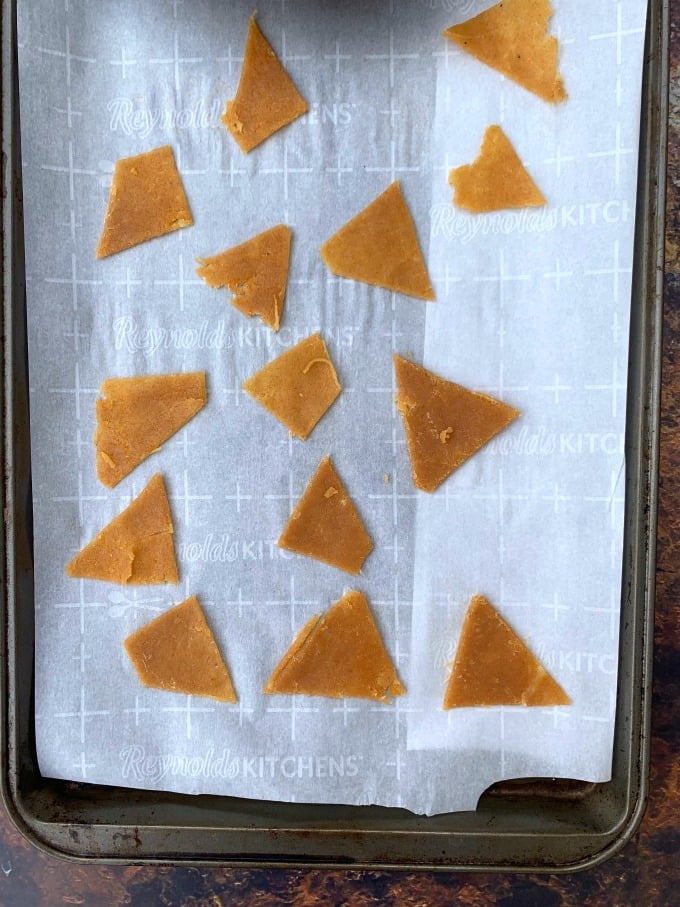 keto tortilla chips dough sliced in triangles on a sheet pan